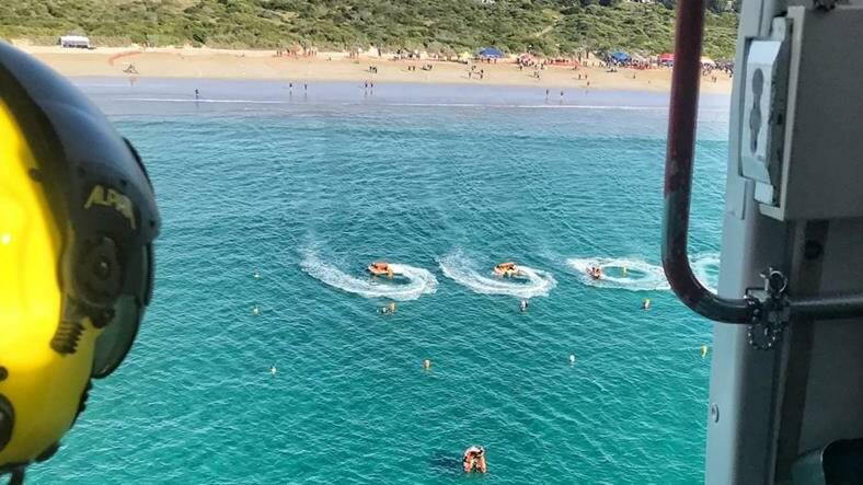 RESCUE RACE: A Batemans Bay Inflatable Rescue Boat (IRB) crew saved an angler swept from rocks, as hundreds of lifesavers competed in an IRB competition at a neighbouring beach. Picture: supplied.