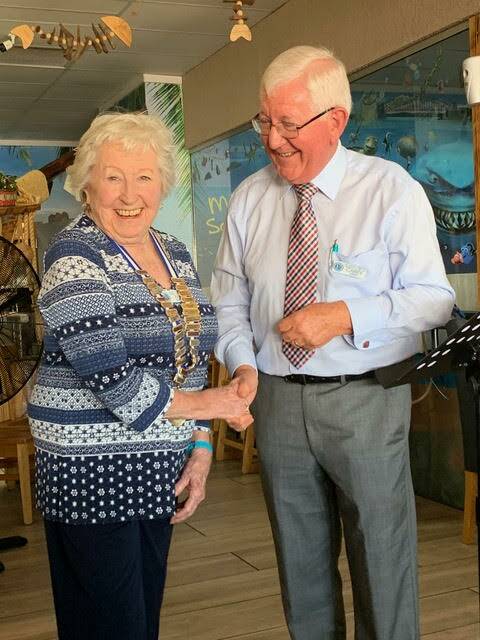 CONGRATULATIONS: Tollgates Probus Club of Batemans Bay outgoing president Garry Gray welcomes incoming president Jean Baker. Picture: supplied