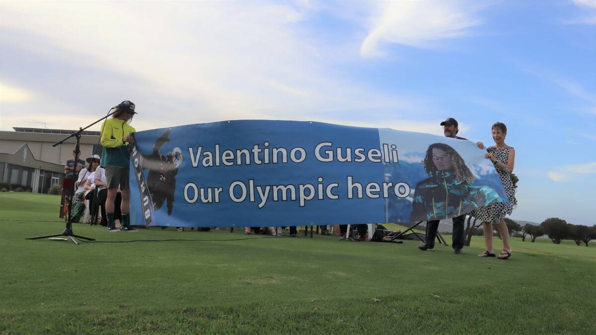 OUR HERO: Valentino Guseli was gifted a supporter banner, made by the Narooma Business Chamber. He was welcomed home on Wednesday at a civic reception.