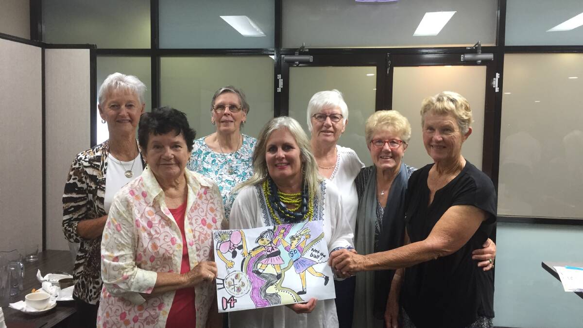 Gillian Kearney holding her winning Squiggle pictured with her team at the Narooma Netball trivia night in 2017.