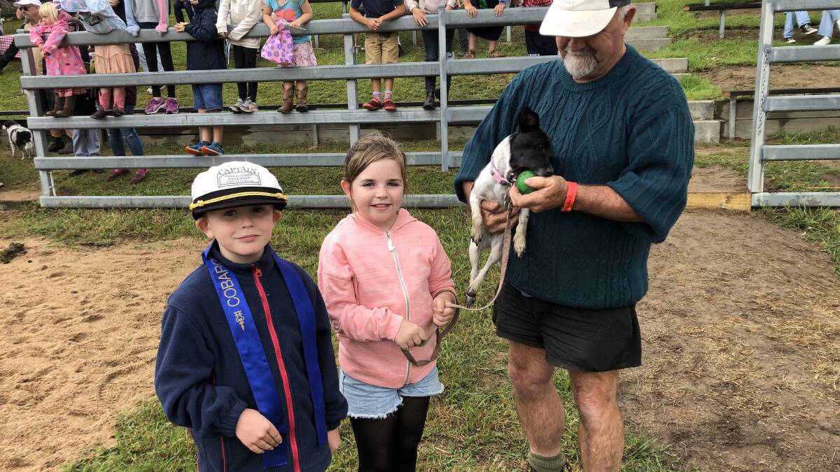 Winner of the mini dog race Maggi with Isaac and Mia and their 'Pop'. Picture by Marion Williams