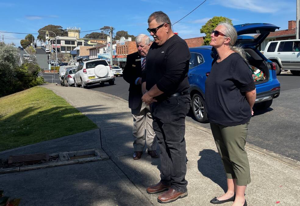 Mal and Erin Barry (and Narooma RSL sub-Branch president Paul Naylor in the background) pay their respects after a wreath was laid at the foot of the Narooma War Memorial Clock Tower for a rededication ceremony on Tuesday, August 29. Picture by Marion Williams