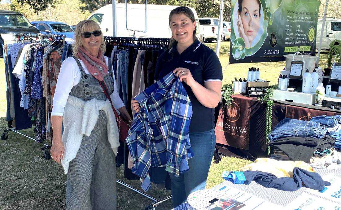 Council sustainability officer Allana Haines (right) shows a community member they can give five items and take five items of clothing at a swap event. Picture via Eurobodalla Shire Council