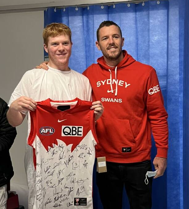 Days after Tom went into cardiac arrest at school, the Narooma Lions under 17s captain was visited by Sydney Swans captain Luke Parker at St George Hospital in Sydney. Picture via Sydney Swans/Facebook