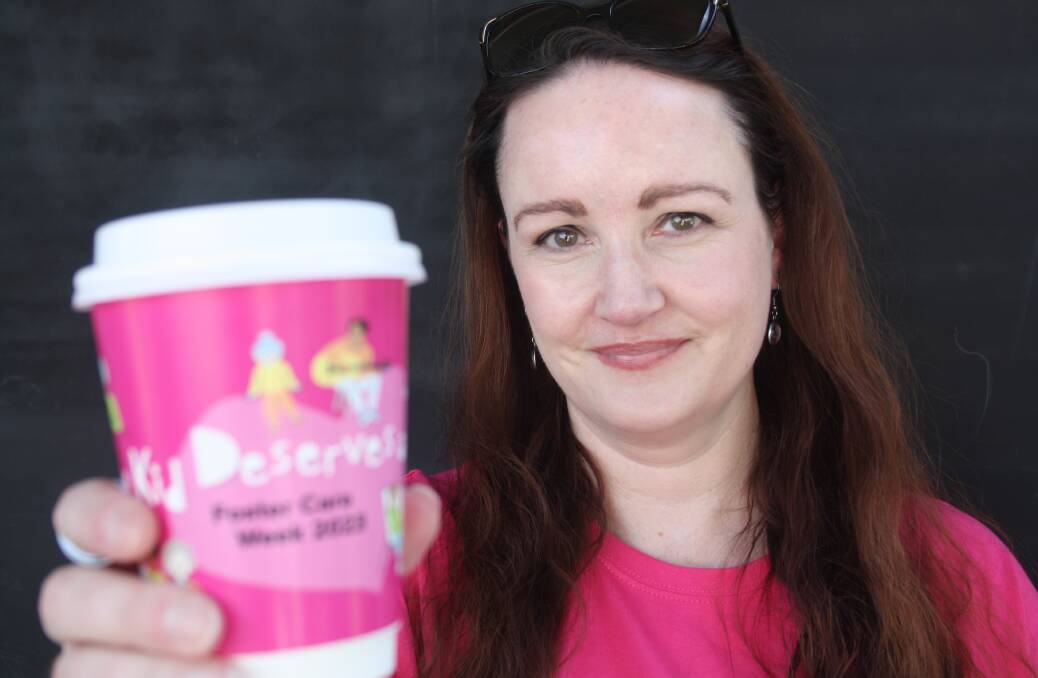Rebecca Henderson from CareSouth with one of the cups being used to call for more foster carers in the Eurobodalla. Picture by Glenn Ellard.