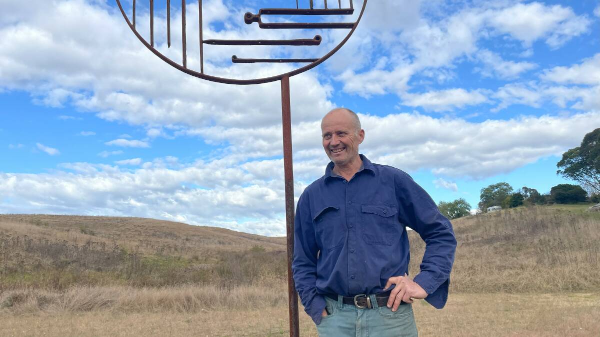 Richard Moffatt leaning on one of the sculptures on his property in Buckajo. Picture by James Parker.