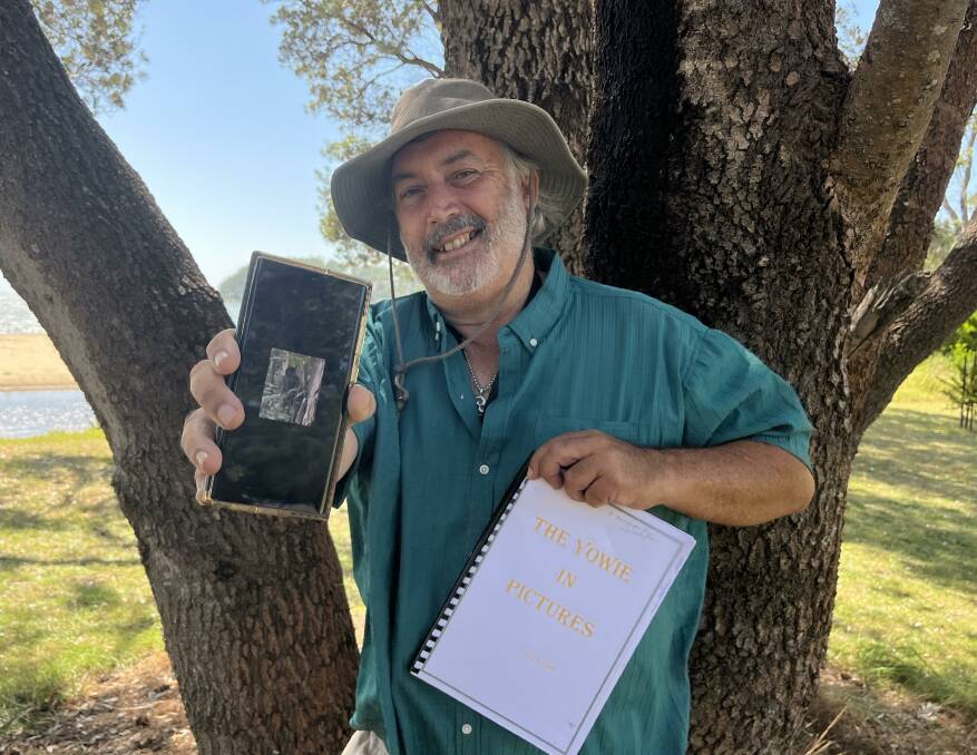 Enthusiastic Yowie researcher Wayne Lewin holding his phone with an image he had captured and a book of photographs. Picture by James Parker