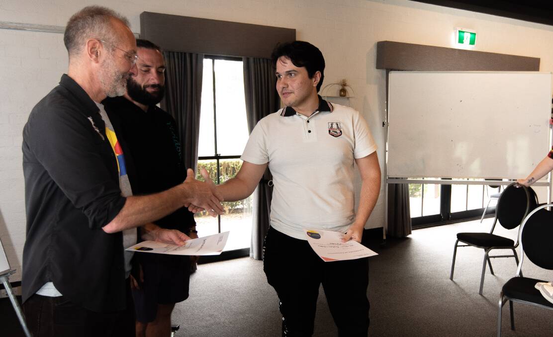 Batemans Bay High student Jackson Gorham-Nolan shakes trainer Frank Newman's hand after completing the Invest in Yourself: Exploring Money & Self-Employment workshop. Picture by Nick Peters Photography