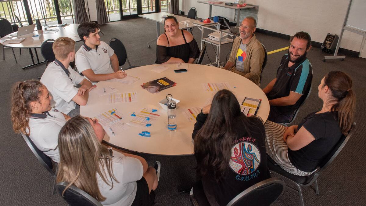 Batemans Bay High School students discuss money matters with trainer Frank Newman from the Sydney School of Entrepreneurship. Picture by Nick Peters Photography