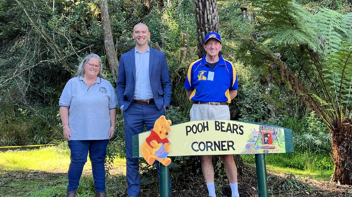 Artist Rose Gauslaa, Eurobodalla Shire Mayor Mathew Hatcher and David Trickett from the Narooma Men's Shed with the sign back in place on the Clyde. Picture by Eurobodalla Shire Council