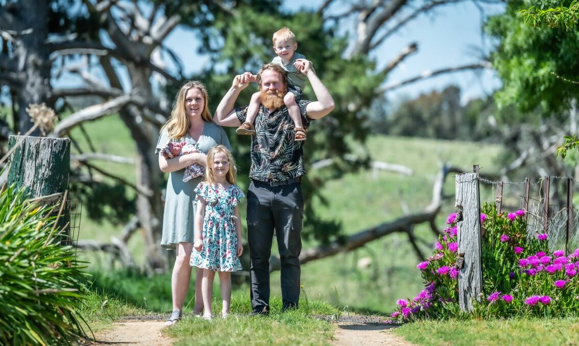 Lauren and Aaron Ludwig, at home in Binalong on Thursday, with their children newborn Ivy, Scarlett, six, and Remy, three. Picture by Karleen Minney 