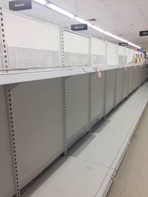 The almost empty toilet paper shelves at Coles, Batemans Bay, on March 5. A few rolls can be spied in the distance.