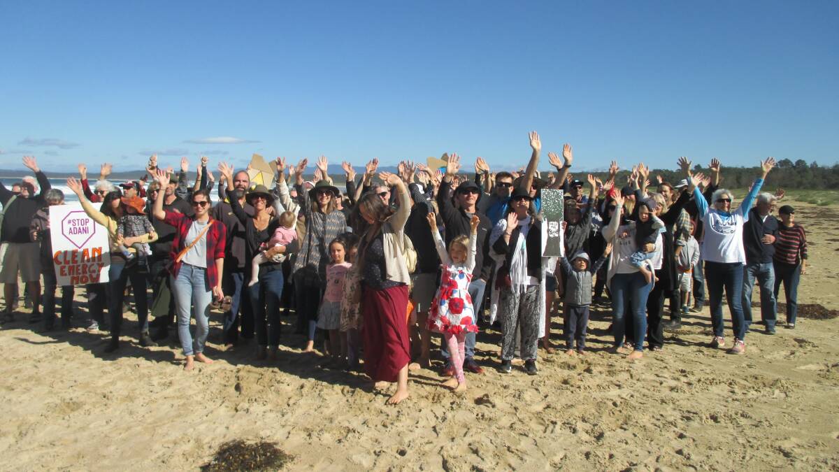 SHOW OF HANDS: A climate rally was held on Broulee Beach on Saturday in the lead-up to the May 18 federal election.