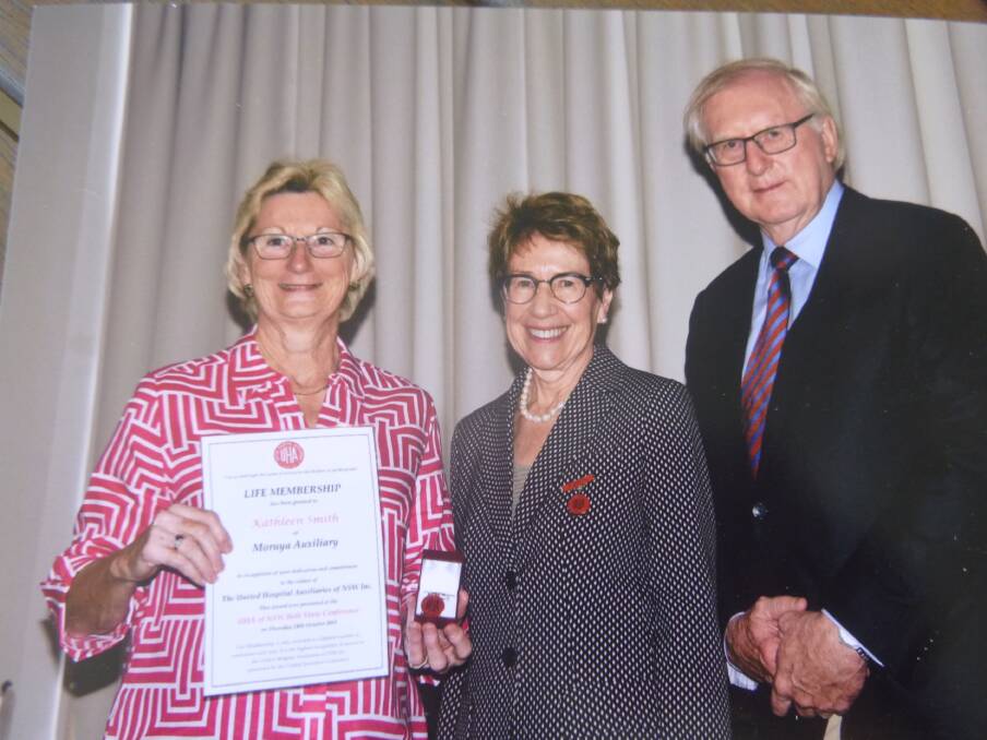 SERVICE: Kath Smith receives her life membership from NSW Governor Margaret Beazley and her husband Dennis Wilson.
