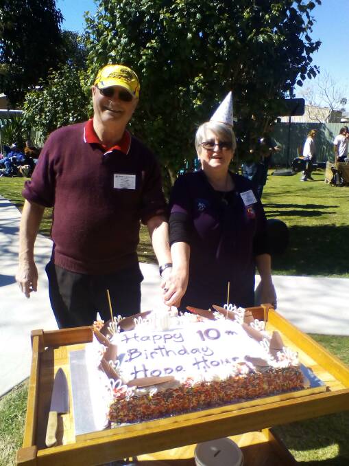 Community Life President Dennis Hughes and Hope House manager Shirley Diskon cut the 10th birthday cake.