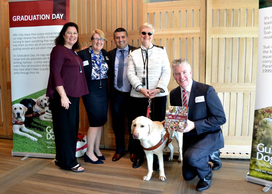 WHAT A DOG: Elaine Heskett and Mr Darcy with representatives of the NSW Taxi Council at the Opera House on Monday for the launch of 60 Tails.