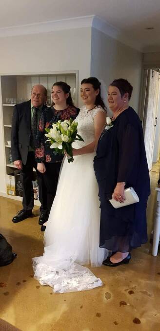 Fashionista: Rebecca Scott on her big day last Saturday with father John, sister Maddy and mum Sonia. Groom, Drew De Graaf, waited anxiously in the rain!