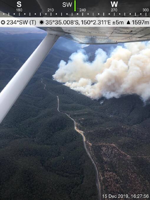 This picture taken shortly before 4.30pm on Sunday, December 15, shows fire has broken containment lines north of the Kings Highway. The highway is closed until further notice. PICTURE: RFS.