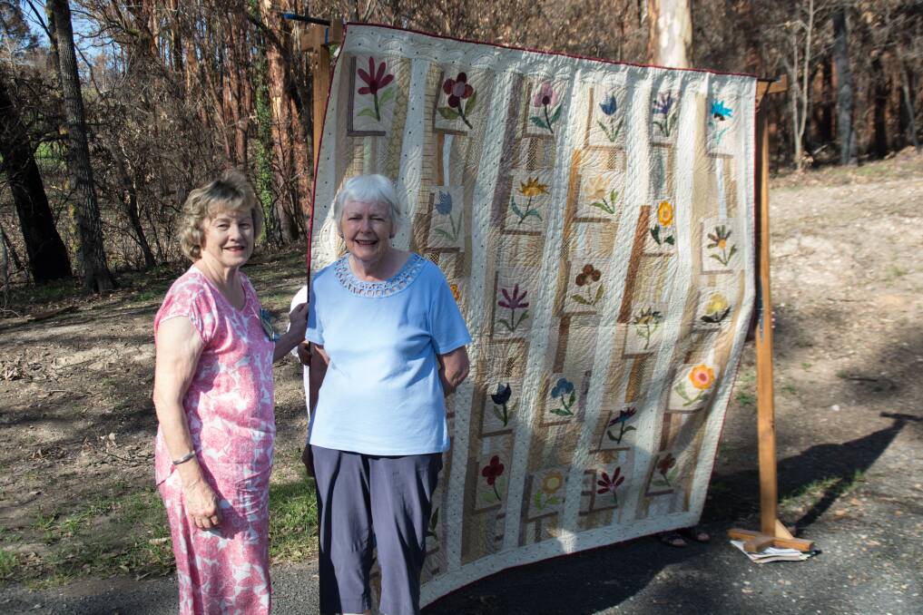 STITCH IN TIME: Friends president Heather Haughton and Night Owls president Julie Criss with the quilt saved from the summer bushfires.