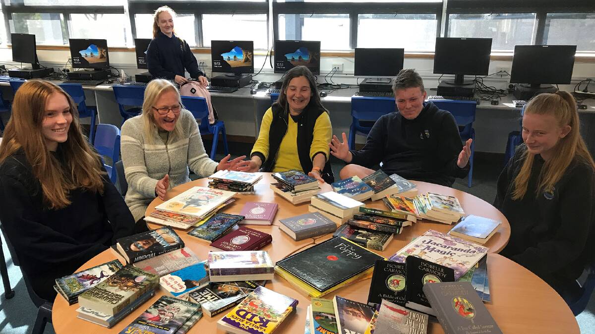 FULLY BOOKED: Staff and students were delighted to unpack this special delivery of books to Moruya High School.