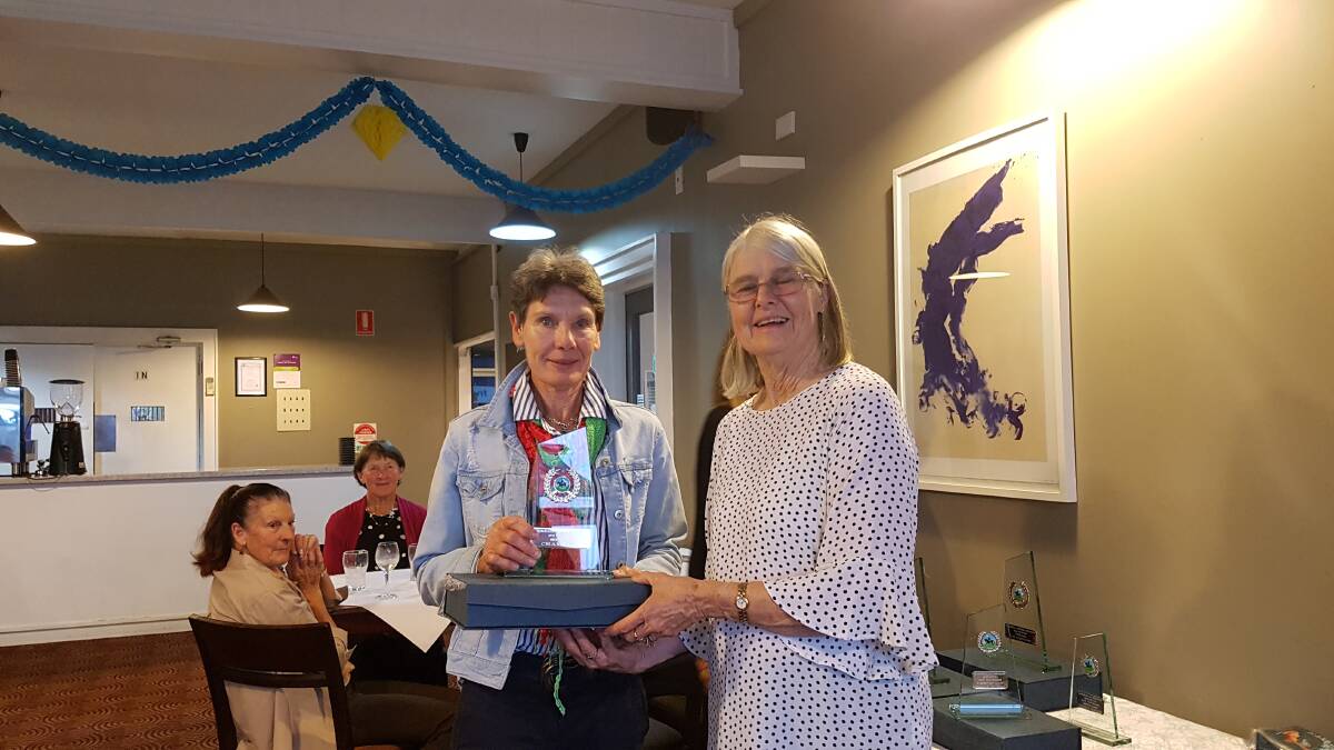 DRESSAGED UP: Club president Fran Sanders presents an award to one of the association's founding members Ann Behringer.