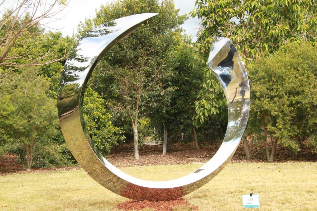 Can you see the waters of Batemans Bay through the "Portal"? David Machlachlan wants to see the Clyde River reflected in the shiny steel of the sculpture. It is installed temporarily at Bawley Point, but a campaign has been launched to buy it for Batemans Bay.