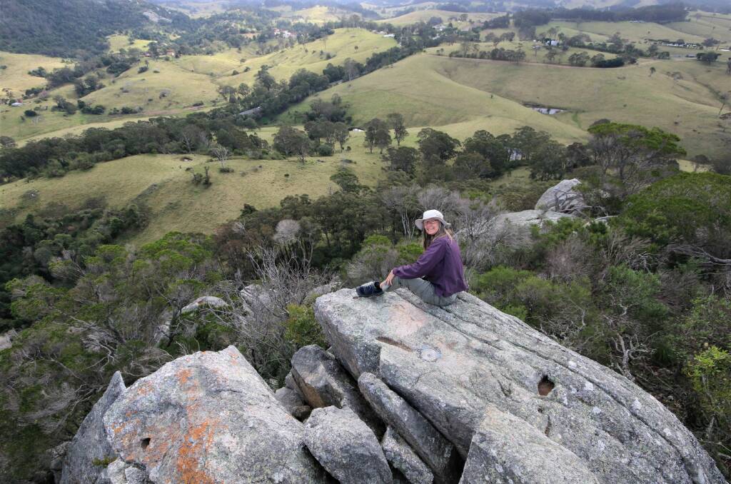 LITTLE BUT WORTH IT: Erika Cleaver enjoying the views from the top of Little Dromedary in one of three walks Batemans Bay Bushwalkers undertook recently.