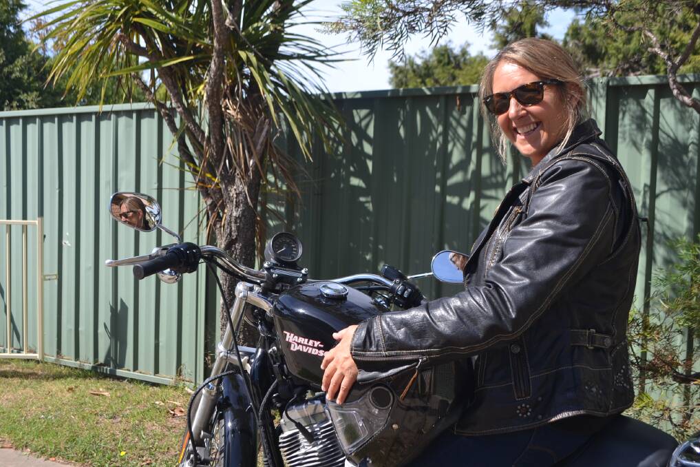 HAPPY WOMEN'S DAY: Mother and motorbike lover Cathy Ferguson celebrates International Women's Day by riding her Harley to work. 