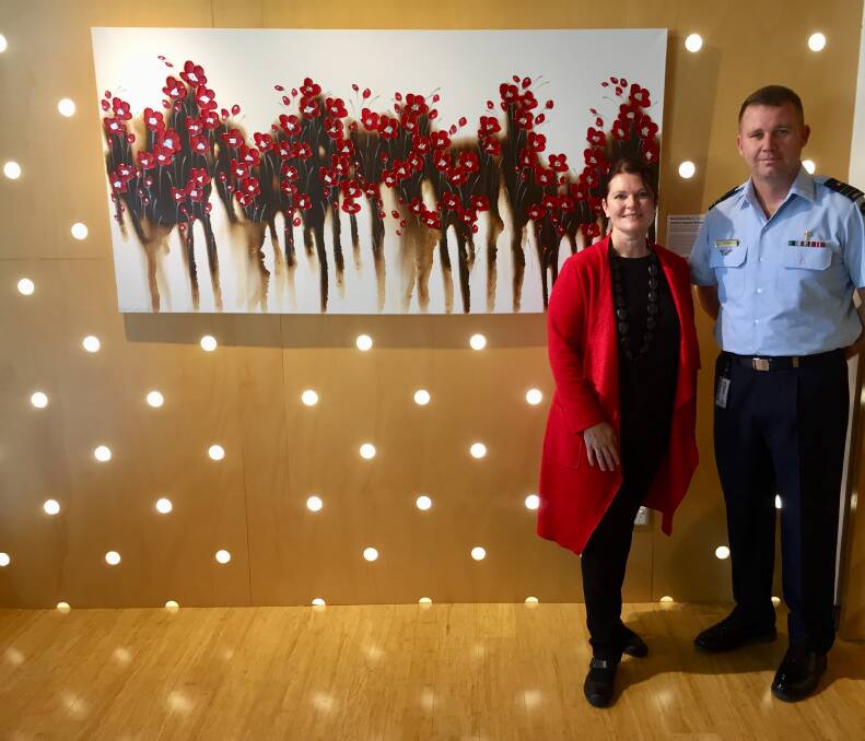 Batemans Bay artist Naomi Crowther, with ADFA Chaplain Wayne Ross, at the official unveiling of her painting "Flanders Poppies Rising". 