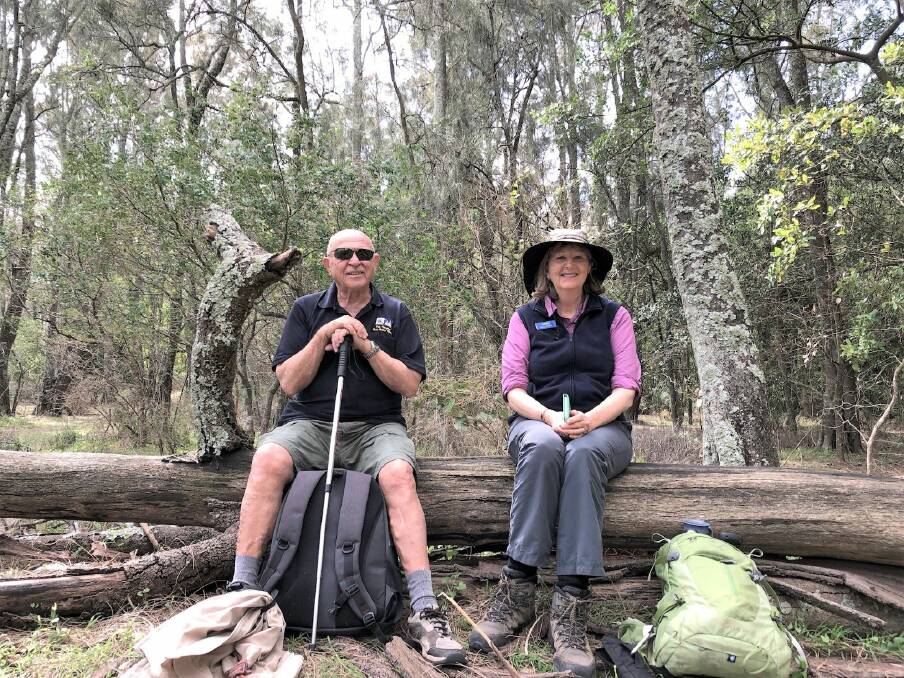 TIME OUT: Simeon Ivanovski and walk leader, Karen MacLatchy taking a short break in Cullendulla Nature Reserve.