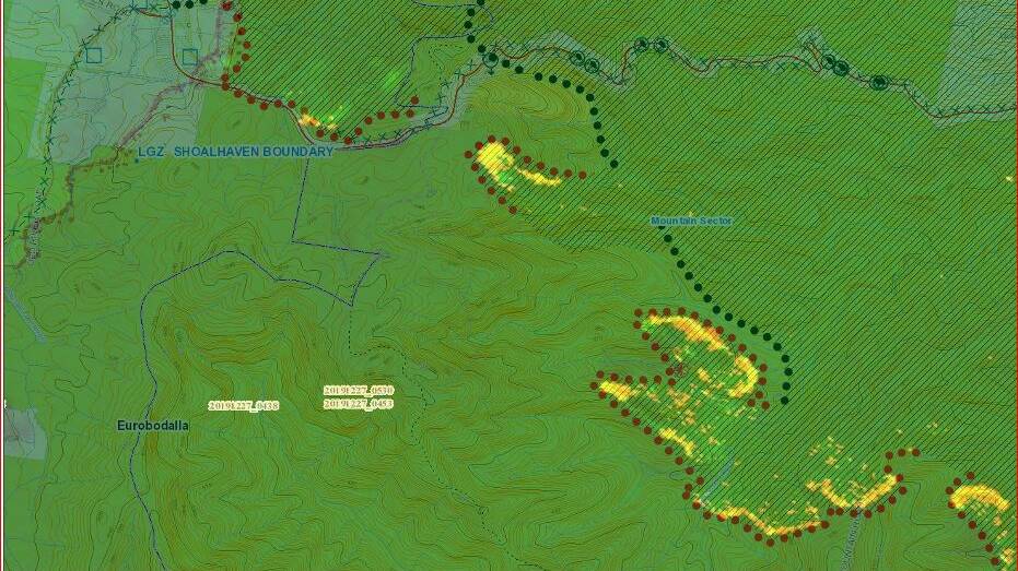 The yellow areas bounded by red spots shows fire burning south of the Kings Highway. A small section in the top left corner is north of the highway, high on the Clyde Mountain. There is a risk this section will join with the southern section, trapping fire and forestry crews. Numerous trees have fallen across the road and burning and dangerous trees remain on either side.