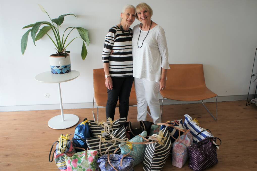 IN THE BAG: Sandy Macklan and Faye Salter with the collection of bags they filled with items for women and teens in crisis.