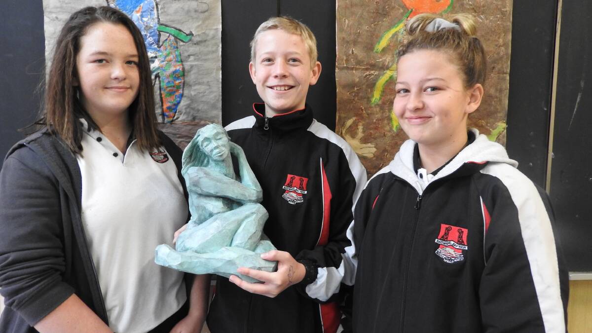 GIFT: Batemans Bay High School's Italia Quinlivan, Dylan Hill and Mia Bryce-Glen with Susan McAlister's "Firefly". Student sculptures are on display in the Bay CBD.