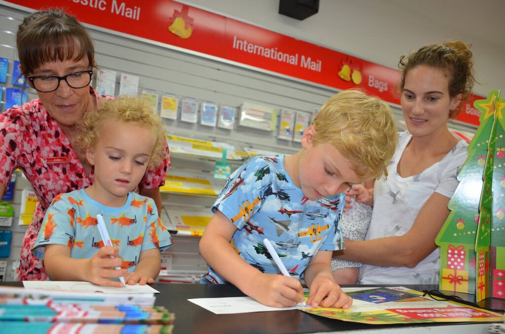POST-HASTE: When it comes to writing to Santa, Australia Post's Julie Moore and Shepheard brothers Toby and Ethan and mother Jess know time is pressing.