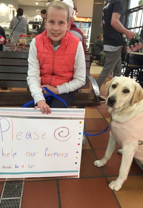 TAKING A LEAD: Kate Kavanagh and Anney traded puppy pats for drought donations.