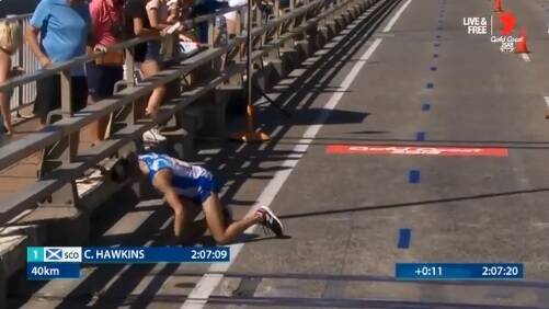 IN DISTRESS: An exhausted Callum Hawkins collapses after leading the Commonwealth Games 2018 marathon in the Gold Coast heat. He could not continue.