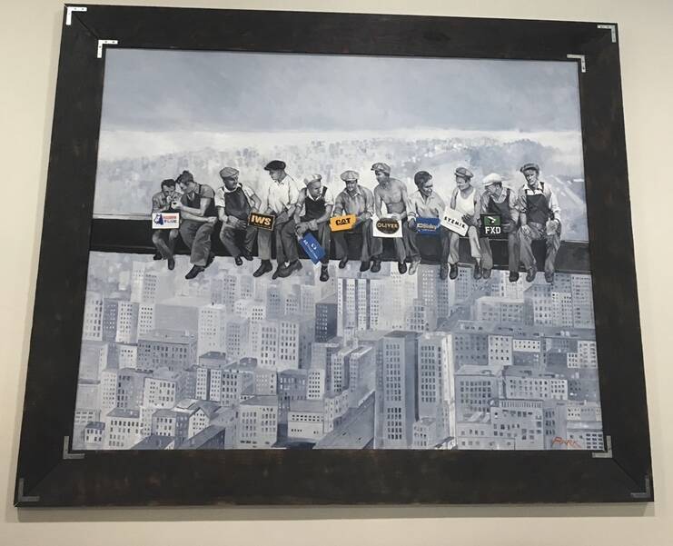 Inspired by the famous 1932 photograph of Empire State Building construction workers (Lunch atop a Skyscraper), David Byard painted this large mural for grandaughter Katie Muller - with a few tweaks to the lunch boxes befitting her work-wear business.