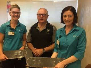 GREAT SKATES: Rehab staff were delighted to accept skate boards from Tuross Head Men's Shed to help patients recover from knee operations.