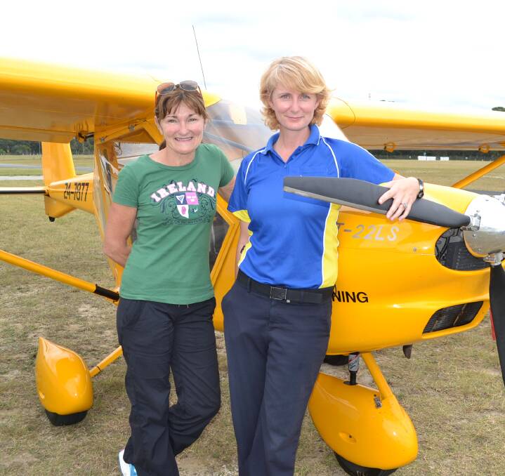 WINGED WOMEN: Malua Bay flying student Cheryl Wallace with Moruya instructor Claire Ferguson and a Aeropakt Foxbat light aircraft at Moruya.