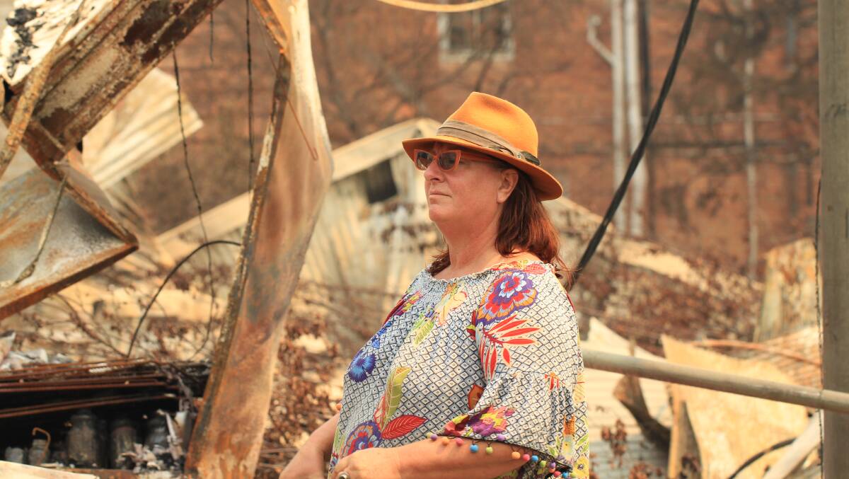 Narelle Storey looks over the devastation in her home town of Cobargo following the New Year's bushfires.