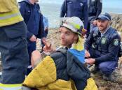 Ben Davidson is cared for by emergency services while awaiting the Toll Air Ambulance after his accident at Tathra on June 18. Photos: Supplied