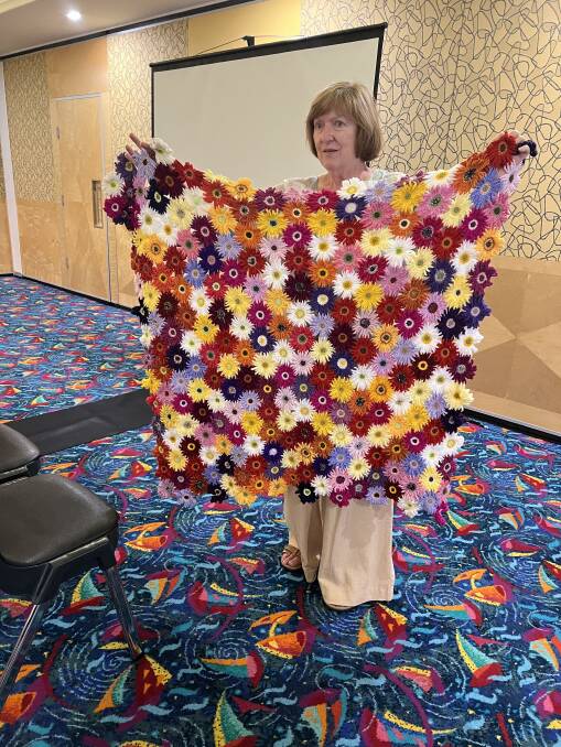 Tracey showing the rug she crocheted for a major raffle