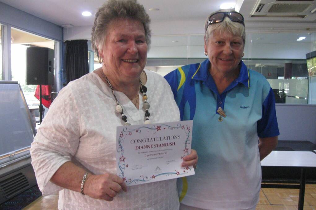 MALUA BAY WOMEN: Di Standish receives her 10-year certificate from president Robyn  Butcher.