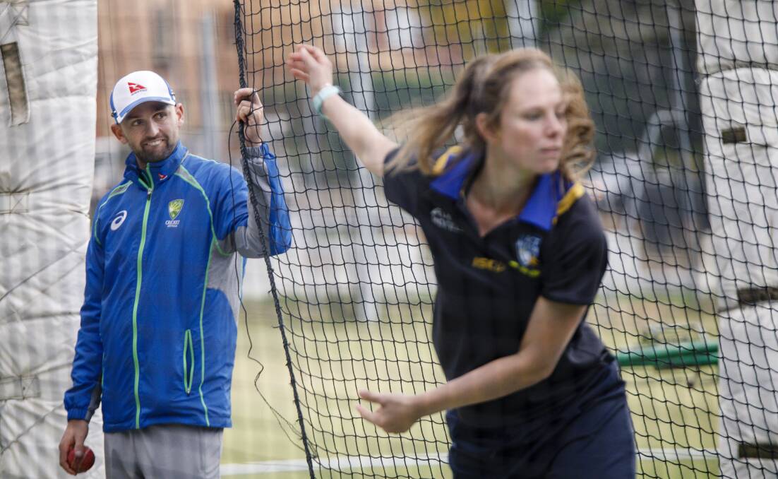 Nathan Lyon watches Sam Bates bowl during a net session with the ACT Meteors. Photo: Sitthixay Ditthavong