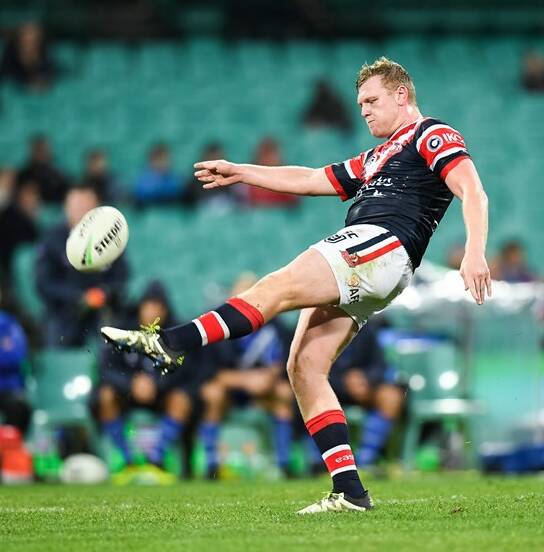 Drew Hutchison puts a kick in for the Roosters. Photo: ROOSTERS MEDIA