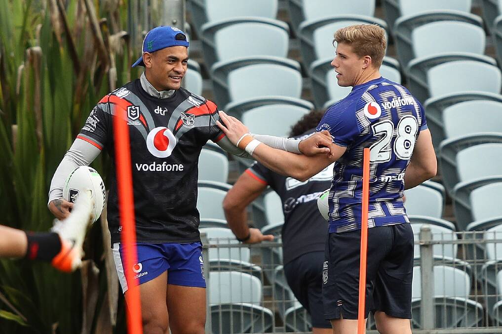 Jack Murche (right) warms up at New Zealand Warriors training on Friday. Photo: Paul Barkley/NRL Imagery