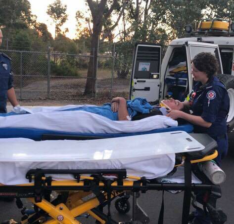 Darcy McKay on a stretcher as emergency services guide him into the 4x4 paramedic vehicle. 