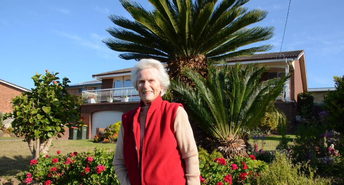Edna McDowall stands in front of her impressive and sentimental cycad revoluta. Cycads are ancient cone-bearing plants that co-existed with dinosaurs. 