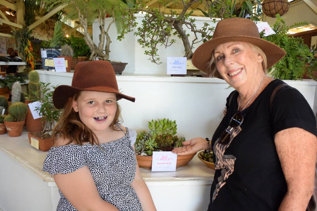 On again: Stevie Spillman and Carol Goddard with their prize-winning plant at the 2019 Kangaroo Valley Show (far left).