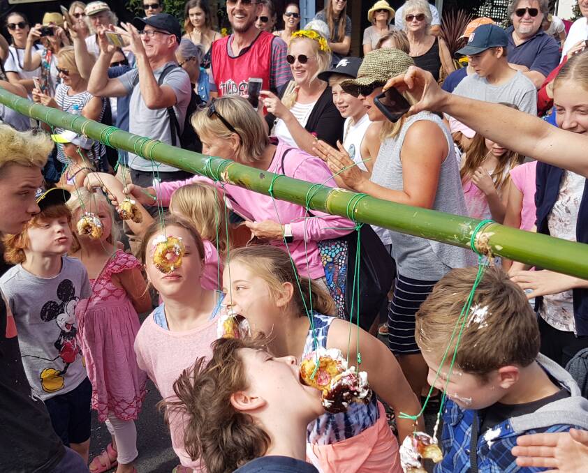 Donut race: Children having a blast at The Tilba Easter Festival in 2017.